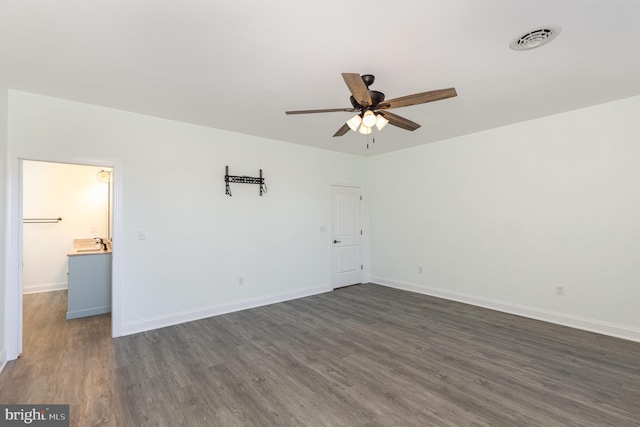 unfurnished bedroom featuring dark hardwood / wood-style floors and ceiling fan