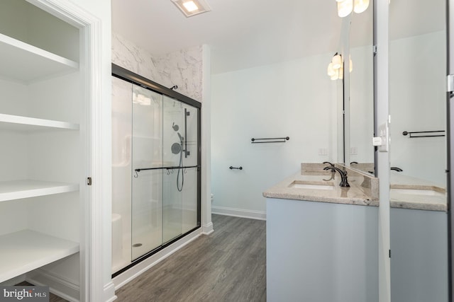 bathroom featuring vanity, hardwood / wood-style flooring, and an enclosed shower