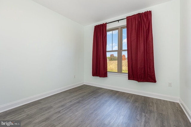 unfurnished room featuring dark hardwood / wood-style flooring