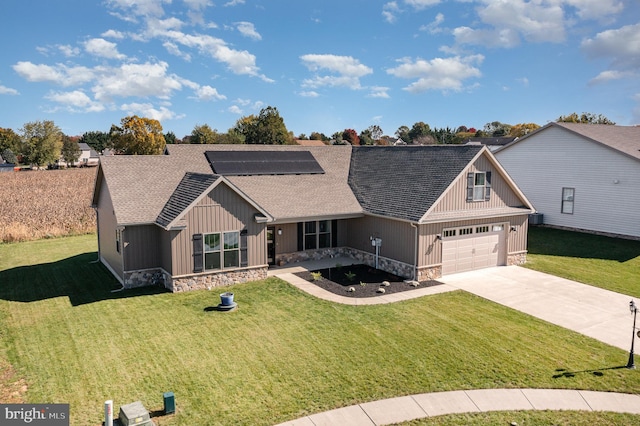 view of front of property with solar panels and a front lawn