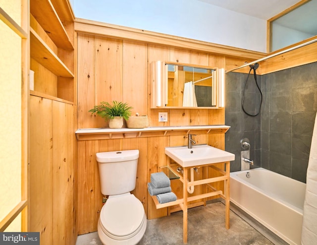 bathroom with concrete floors, toilet, shower / bathtub combination with curtain, and wood walls