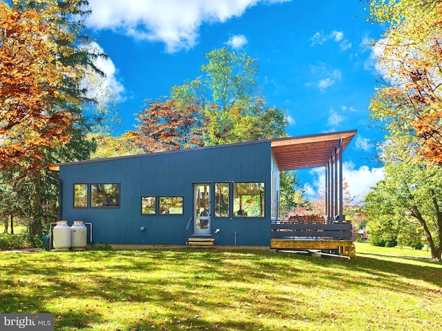 rear view of property featuring a yard