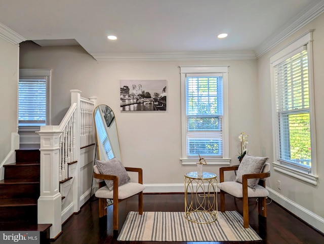 sitting room with ornamental molding, plenty of natural light, and dark wood-type flooring