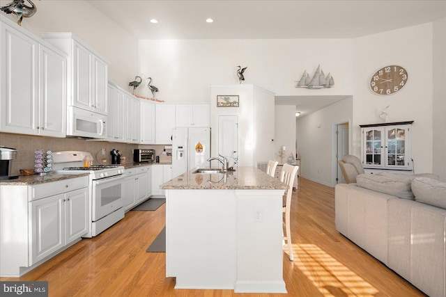 36865 Herring Way, Selbyville, DE 19975 - kitchen with white appliances, white cabinetry, light wood-style floors, high vaulted ceiling, and recessed lighting