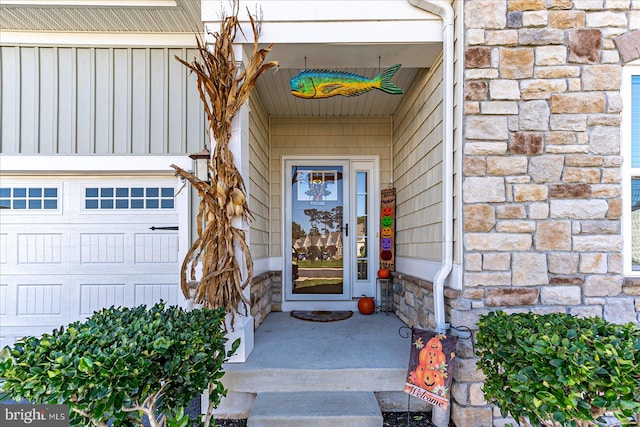 view of exterior entry with a garage