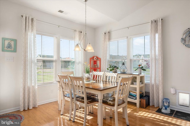 dining room with hardwood / wood-style flooring and lofted ceiling