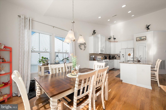 dining area featuring sink and light hardwood / wood-style floors