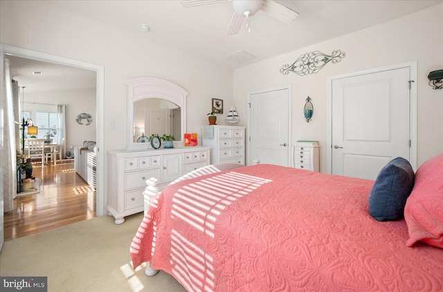 bedroom with ceiling fan and light hardwood / wood-style flooring