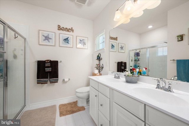 bathroom with vanity, tile patterned floors, toilet, and an enclosed shower