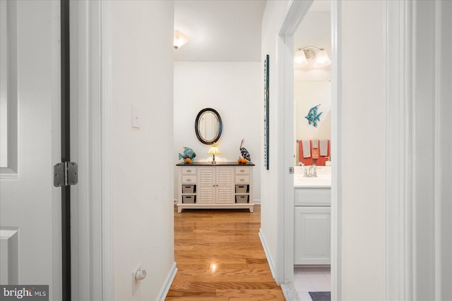 hallway featuring light hardwood / wood-style floors and sink