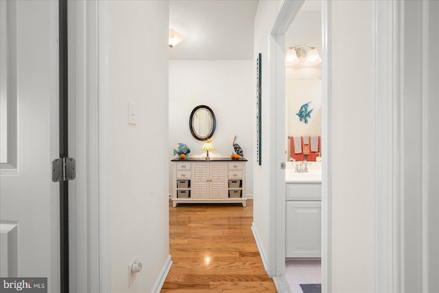 36865 Herring Way, Selbyville, DE 19975 - hall with a sink, light wood-style floors, and baseboards