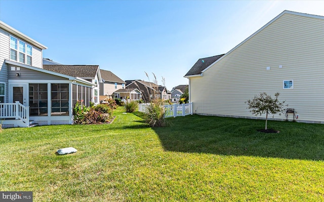 view of yard featuring a sunroom