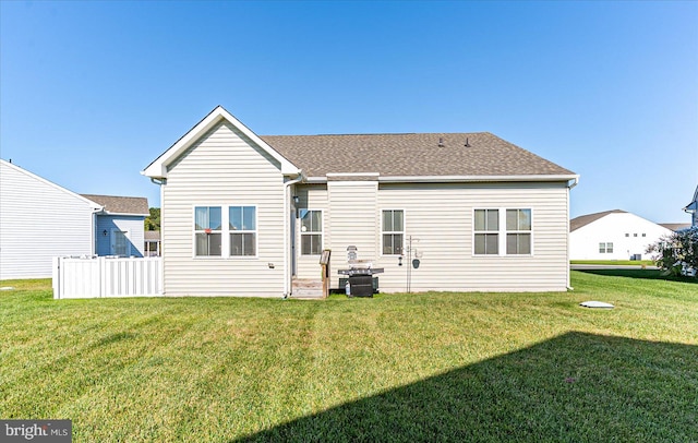 back of house featuring a yard