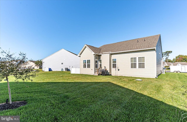 rear view of house with a lawn