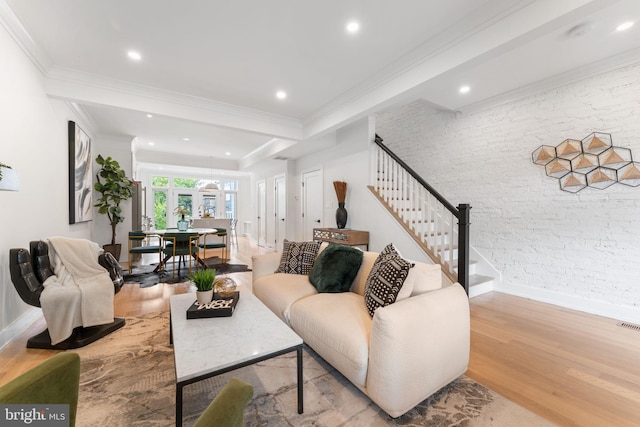 living room featuring beamed ceiling, crown molding, and light hardwood / wood-style flooring