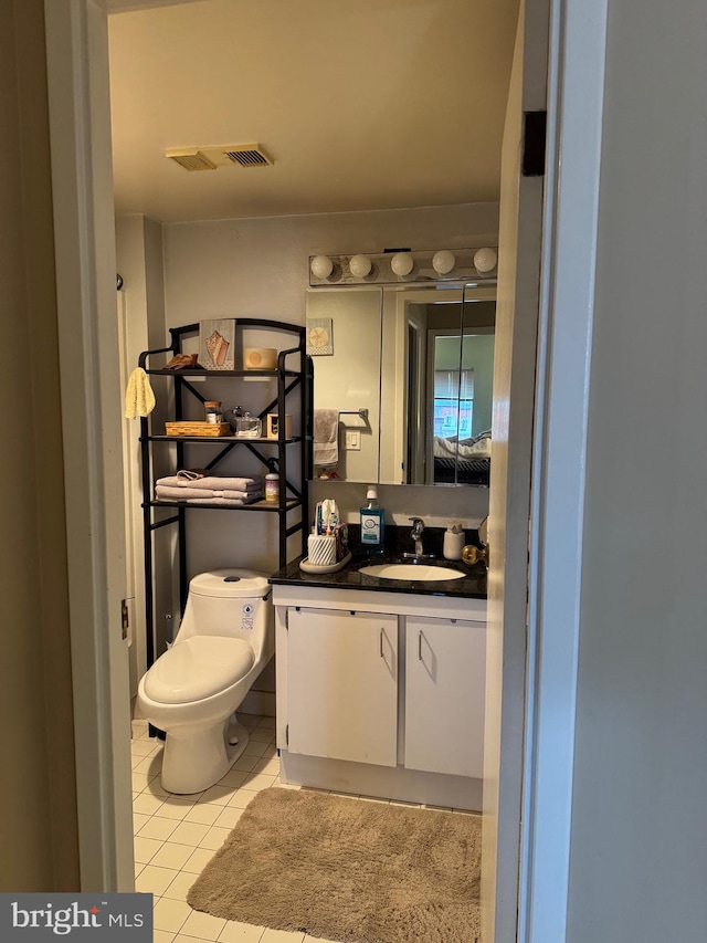 bathroom with tile patterned floors, toilet, and vanity