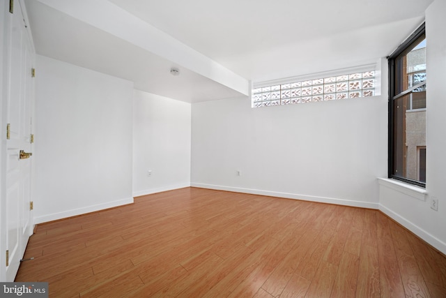 spare room featuring wood-type flooring