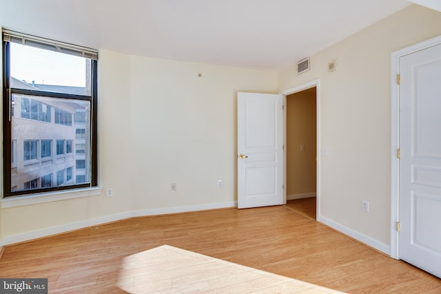 unfurnished room with light hardwood / wood-style floors