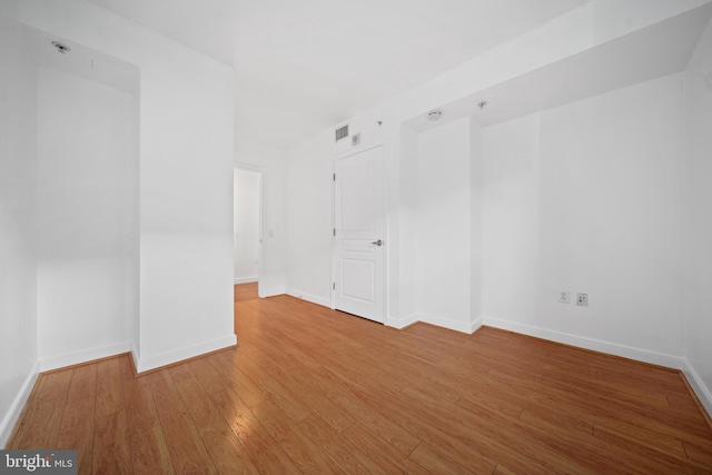 unfurnished room featuring hardwood / wood-style flooring