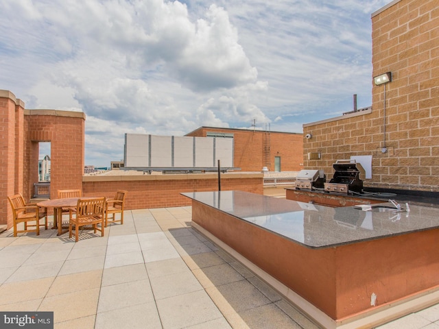 view of patio with an outdoor kitchen and a grill