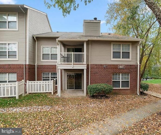 rear view of house featuring a balcony