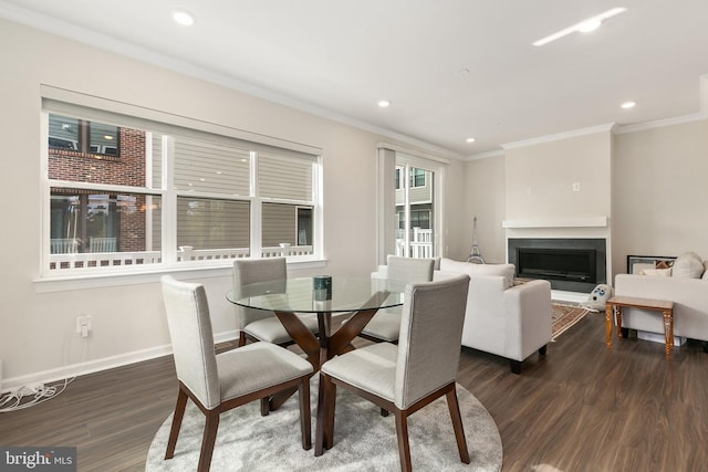 dining space featuring ornamental molding and dark hardwood / wood-style floors