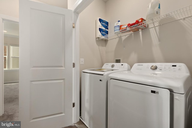 laundry room featuring carpet flooring and separate washer and dryer