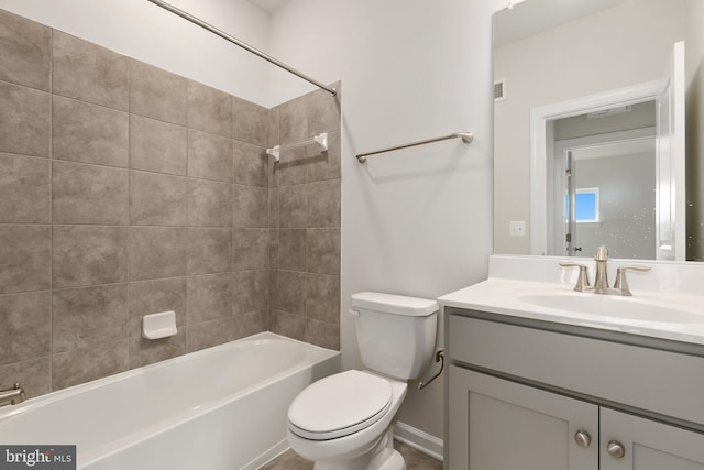 full bathroom with vanity, tiled shower / bath, and toilet