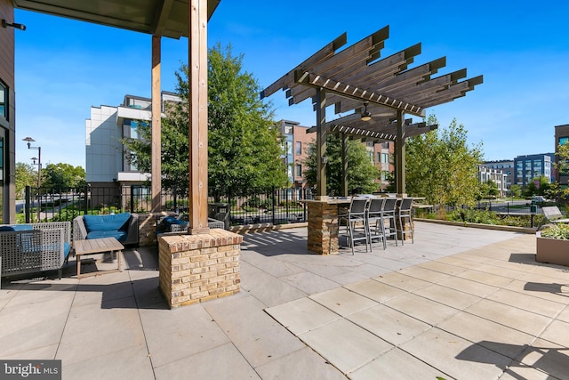 view of patio with exterior bar and a pergola