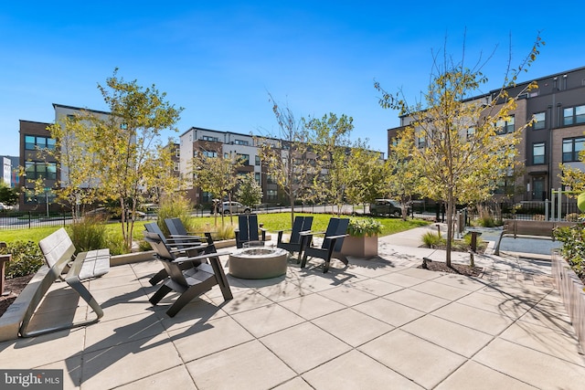 view of home's community featuring a patio and a fire pit