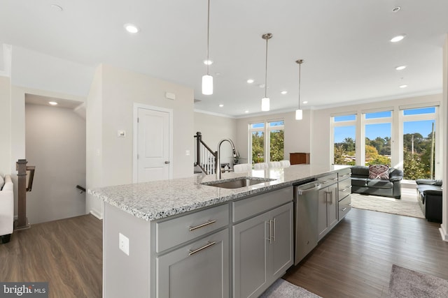 kitchen featuring dark hardwood / wood-style flooring, dishwasher, sink, and a kitchen island with sink