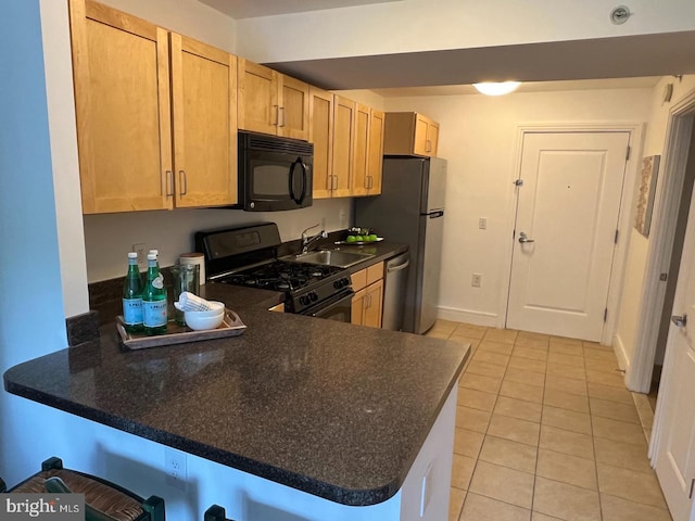 kitchen with light brown cabinets, light tile patterned floors, sink, kitchen peninsula, and black appliances