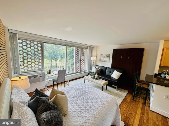 living room featuring cooling unit and light hardwood / wood-style flooring