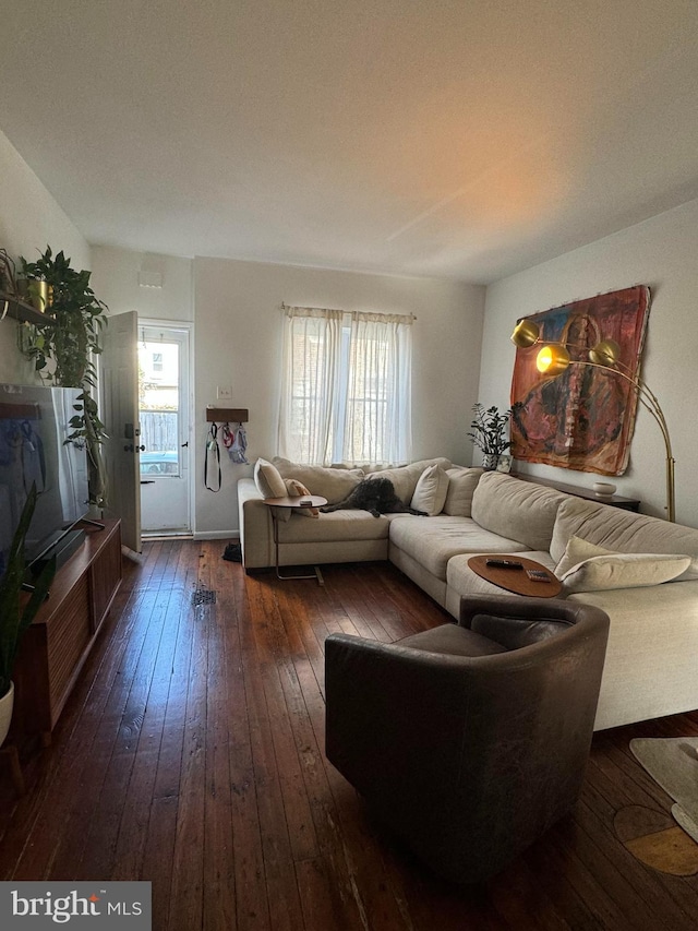 living room with plenty of natural light and dark hardwood / wood-style floors