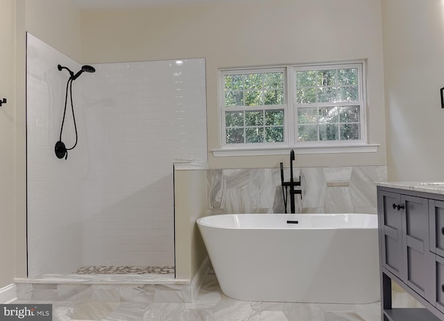 bathroom featuring vanity and shower with separate bathtub