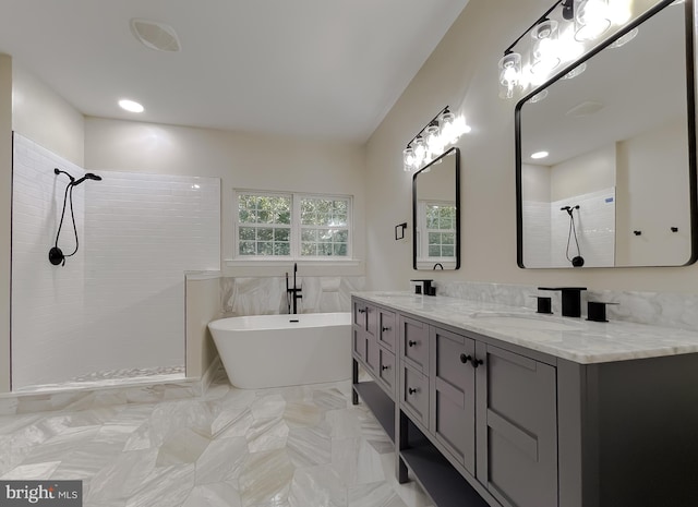 bathroom with vanity and separate shower and tub