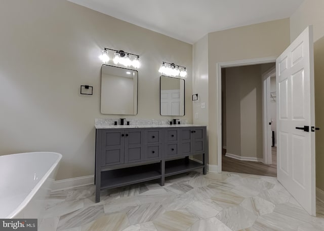 bathroom featuring vanity and a tub to relax in