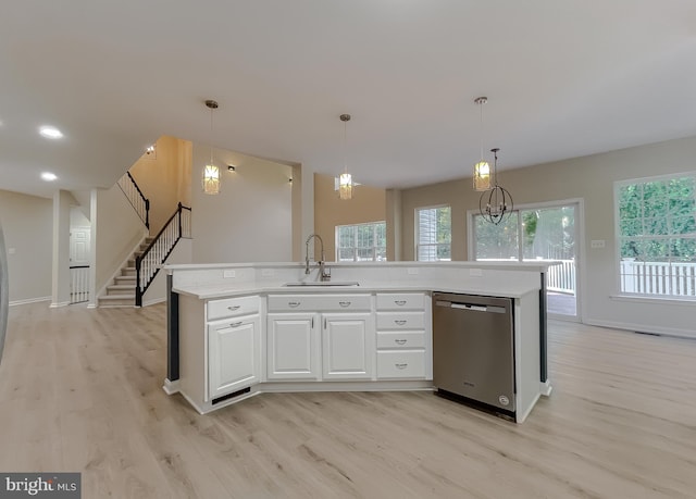 kitchen featuring sink, light wood-type flooring, white cabinetry, pendant lighting, and stainless steel dishwasher