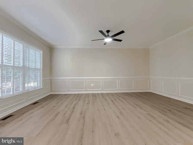 spare room featuring light hardwood / wood-style floors, ornamental molding, and ceiling fan