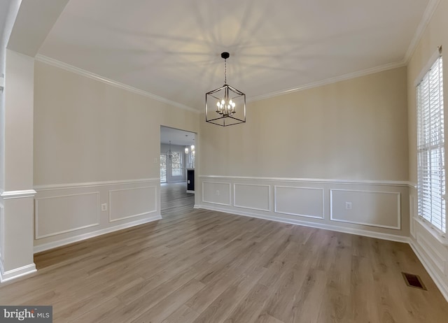 unfurnished dining area featuring crown molding, light hardwood / wood-style flooring, and a healthy amount of sunlight