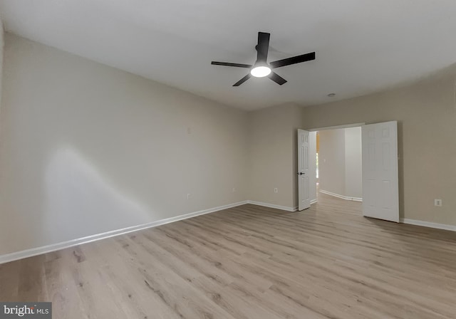 spare room featuring light hardwood / wood-style floors and ceiling fan