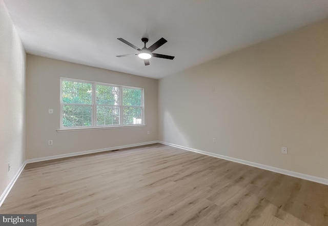 spare room featuring light hardwood / wood-style flooring and ceiling fan