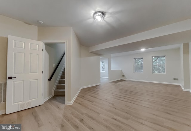 additional living space with light hardwood / wood-style floors