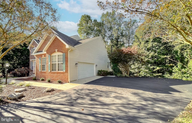 view of side of home featuring a garage