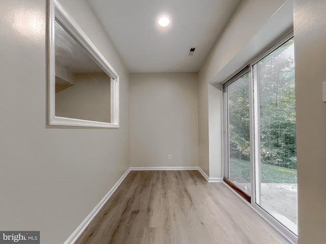 spare room featuring light hardwood / wood-style floors