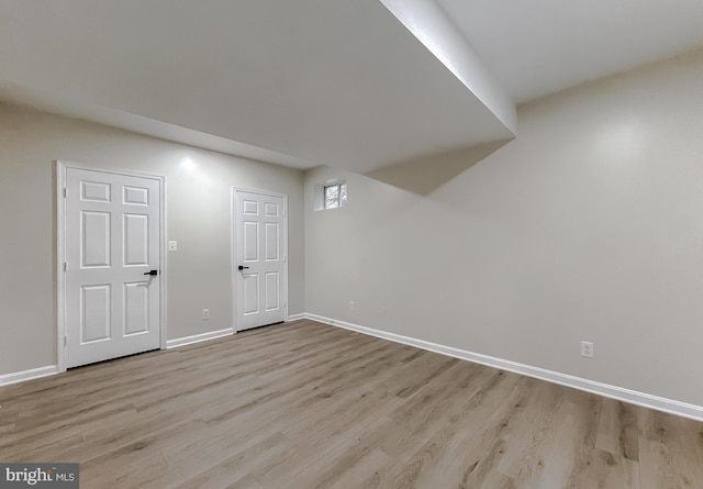 basement with light hardwood / wood-style floors