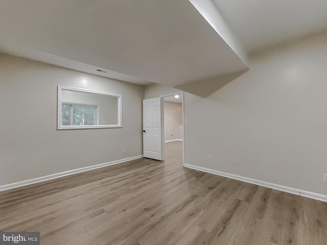 basement with light hardwood / wood-style floors