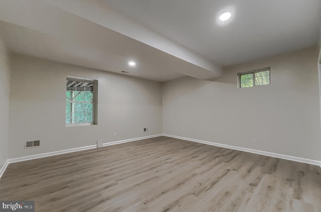 basement featuring light hardwood / wood-style floors and a healthy amount of sunlight