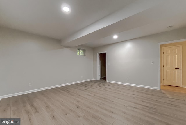 basement with light hardwood / wood-style floors