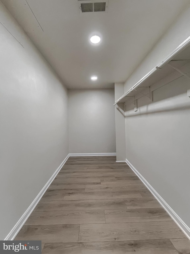 spacious closet featuring hardwood / wood-style floors